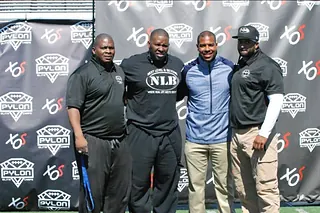 Next Level and Beyond coaching staff at a national elite camp media backdrop