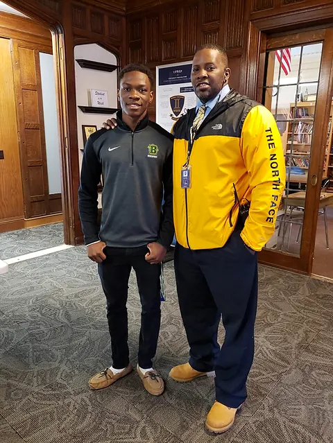 Coach K mentoring a student athlete