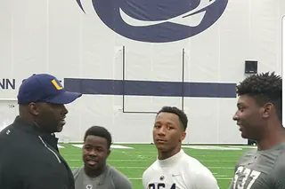High school athletes shaking hands with a college coach on a campus visit