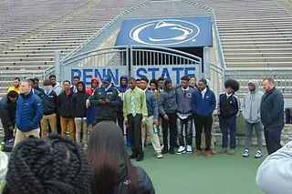 Group of student athletes on an official college campus visit at the stadium