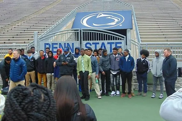 Group of student athletes on an official college campus visit at the stadium