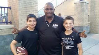 Coach Rick with two young players in Travel 7 on 7 NLB Bats shirts outside a stadium