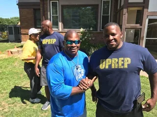 Coaches in Uprep Charter School shirts at a school event in Rochester, New York