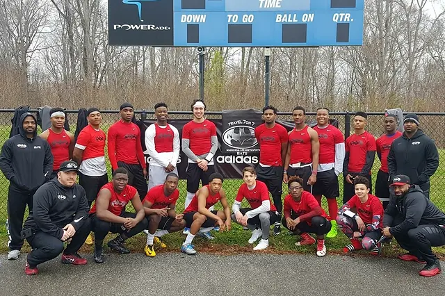 The NLB Bats seven on seven team on a tournament trip in Virginia, beneath a stadium scoreboard